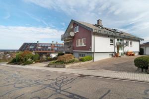 a house with solar panels on the side of a street at Ferienhaus Lydia in Sasbach in der Ortenau