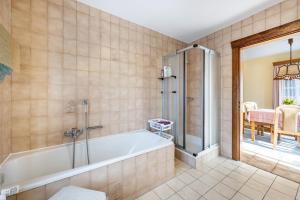 a bathroom with a tub and a walk in shower at Haus Lahrsen in Wesselburen +29 photos