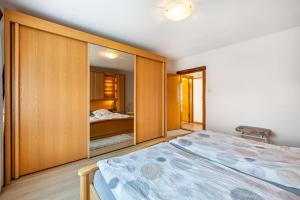 a bedroom with a large bed and a closet at Haus Lahrsen in Wesselburen