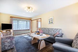 a living room with a couch and a table at Haus Lahrsen in Wesselburen