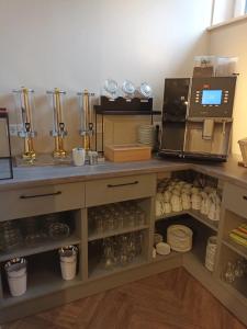 a kitchen with a counter with a coffee machine at Hotel zur Panke Wohnung 2 in Kolonie Röntgental