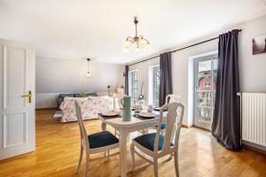 a dining room and living room with a table and chairs at Ferienwohnung Gestüt Kriseby in Lübeck