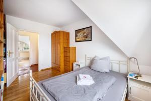 a bedroom with a bed and a staircase at Ferienwohnung Gestüt Kriseby in Lübeck