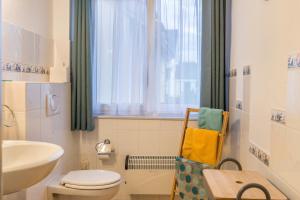 a bathroom with a sink and a toilet and a window at Apfel in Meersburg +14 photos