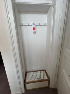 a room with a door with a shelf and white shoes at Harmonija26 in Karlovac