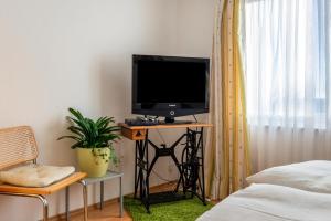 a television sitting on a stand in a bedroom at Apfel in Meersburg