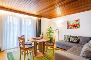 a living room with a table and a couch at Apfel in Meersburg