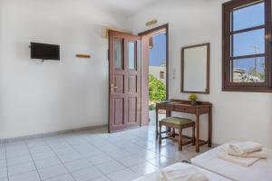 a room with a desk and a mirror and a door at Frantzis studio 3 Nisyros in Páloi