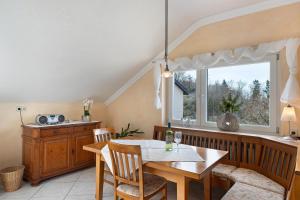 a dining room with a table and a window at Ferienhaus Lydia in Sasbach in der Ortenau