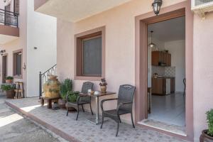 a patio with a table and chairs next to a building at Frantzis studio 3 Nisyros in Páloi