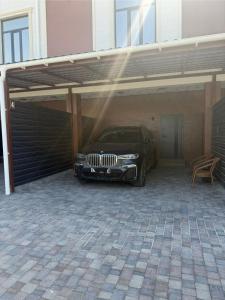 a car garage with a car parked in it at Essenali in Taraz