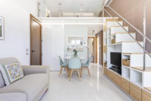 a living room with a couch and a table at Olimar Home in Santa Flavia