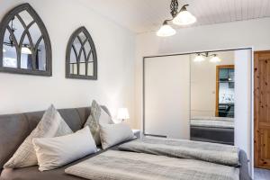 a living room with a couch and a mirror at Ferienwohnung Bernoth in Erfurt