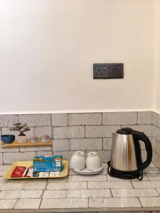 a tea kettle sitting on top of a kitchen counter at Astral Zone Cottage Scenic Mountain view Stay Ella in Ella