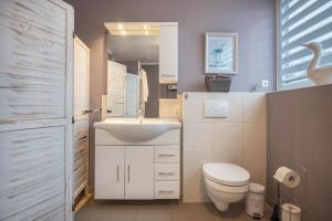 a bathroom with a white sink and a toilet at Haus Erika in Brunsbüttel +18 photos