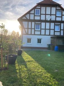 a house with a green yard in front of it at Ferienwohnung Wie zu Hause in Ostritz +13 photos