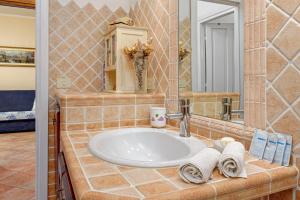 a bathroom with a sink and a mirror at Casa Anna in San Teodoro +14 photos