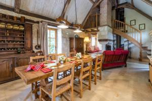 a kitchen and dining room with a wooden table and chairs at Chez Jacquou in Bouniagues