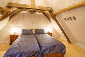 a bedroom with a bed in a attic at Chez Jacquou in Bouniagues +18 photos