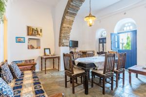 a dining room with a table and chairs at Kykladen White House in Koumáros +17 photos