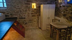 a room with a wooden table and a wooden chair at Pyrgos Mitsakou 2 in Vathia