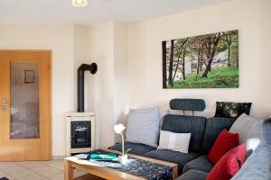 a living room with a couch and a fireplace at Ferienwohnung Tannenblick 8-1 in Oberhof
