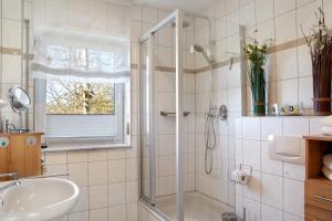 a bathroom with a shower and a sink at Ferienwohnung Tannenblick 8-1 in Oberhof +17 photos