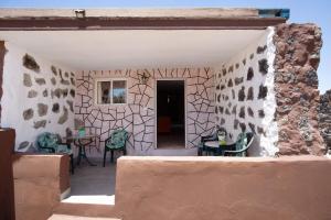 a patio with chairs and a table in a building at Alma Eco-rústico Adults Only in El Charco