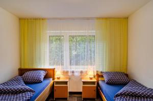 a room with two beds and a window at Haus Störtebeker in Marienhafe