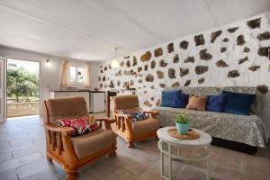 a living room with a couch and two chairs and a table at Alma Eco-rústico Adults Only in El Charco
