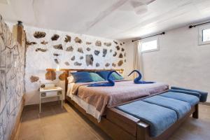 a bedroom with a large bed with blue pillows at Alma Eco-rústico Adults Only in El Charco +12 photos