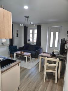 a living room with a blue couch and a table at Ferienwohnung - Wolkow in Wolkow +11 photos
