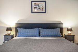 a bedroom with a large bed with blue pillows at Ferienwohnung - Wolkow in Wolkow