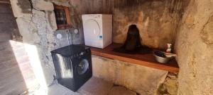 a small kitchen with a stove and a microwave at L'échappée des Rêves in Verchaix +17 photos