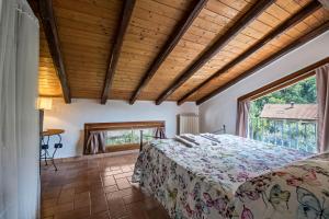 a bedroom with a bed and a large window at Mansarda con vista lago in Sulzano