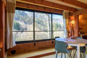 a dining room with a table and a large window at Chalet in Mittlach