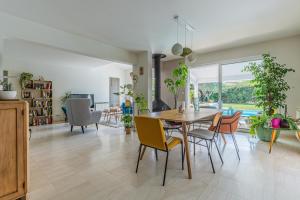a dining room and living room with a table and chairs at Villa Saint-Martin - Pompignac in Pompignac