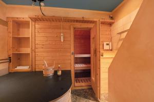 a sauna in a wooden cabin with a counter at Alte Revierförsterei in Börfink +29 photos