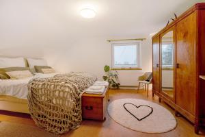 a bedroom with a bed and a heart rug at Alte Revierförsterei in Börfink