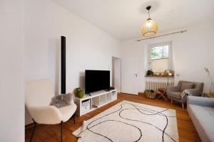 a living room with a television and a couch at Alte Revierförsterei in Börfink