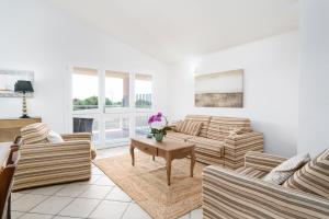 a living room with two couches and a table at La vela gialla in Cala Liberotto