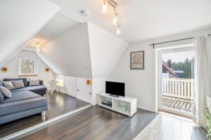 a living room with a couch and a tv at Ferienwohnung Bayerl in Kirchseeon