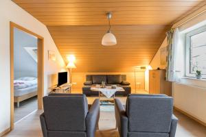 a living room with a couch and a table and chairs at Ferienwohnung Frischauf in Flensburg +10 photos