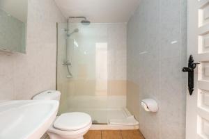 a bathroom with a shower and a toilet and a sink at Apartamento Isla Blanca in Es Pujols +13 photos