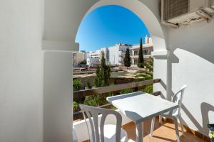 a balcony with a table and chairs and a view at Apartamento Isla Blanca in Es Pujols