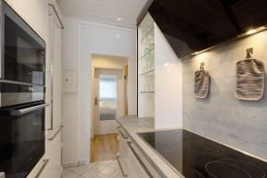 a kitchen with a sink and a stove at Ferienwohnung San Marino 2 in Mücheln +15 photos