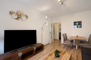 a living room with a flat screen tv on a wall at Ferienwohnung San Marino 2 in Mücheln