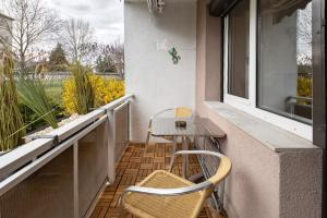 a balcony with a table and chairs and a window at Ferienwohnung San Marino 2 in Mücheln
