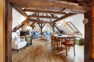 a dining room and living room with a table and chairs at Altes Zollhüsli in Schluchsee