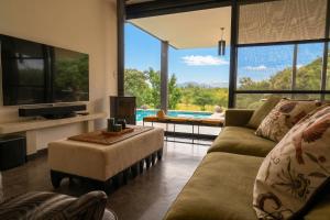 a living room with a couch and a tv at Cypiro Leopard Lodge in Kransberg